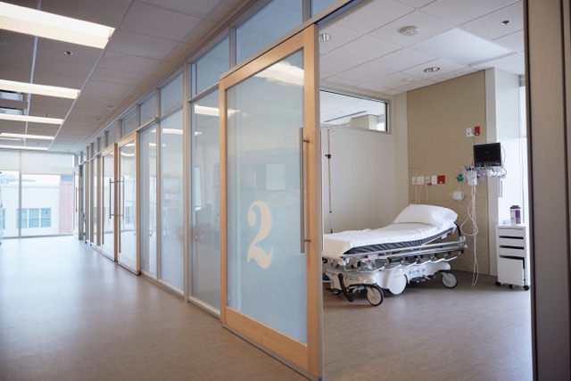 Image taken from hallway looking into hospital room.