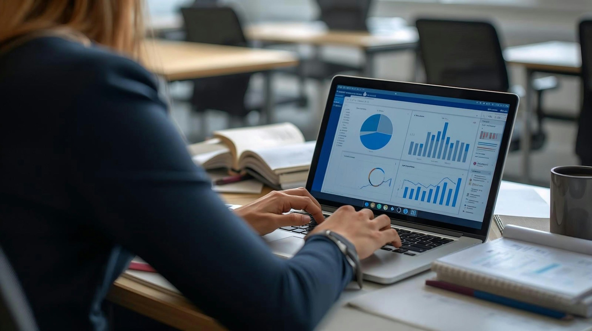 Person working on laptop with statistical bars and graphs